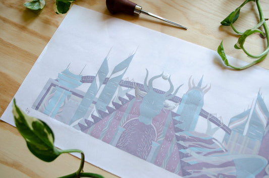 Artistic print of a stylized landscape with sci fi buildings on a wooden surface