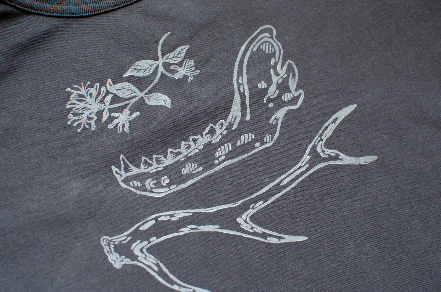 Black t-shirt with hand printed white honeysuckle, jawbone, and antler design.