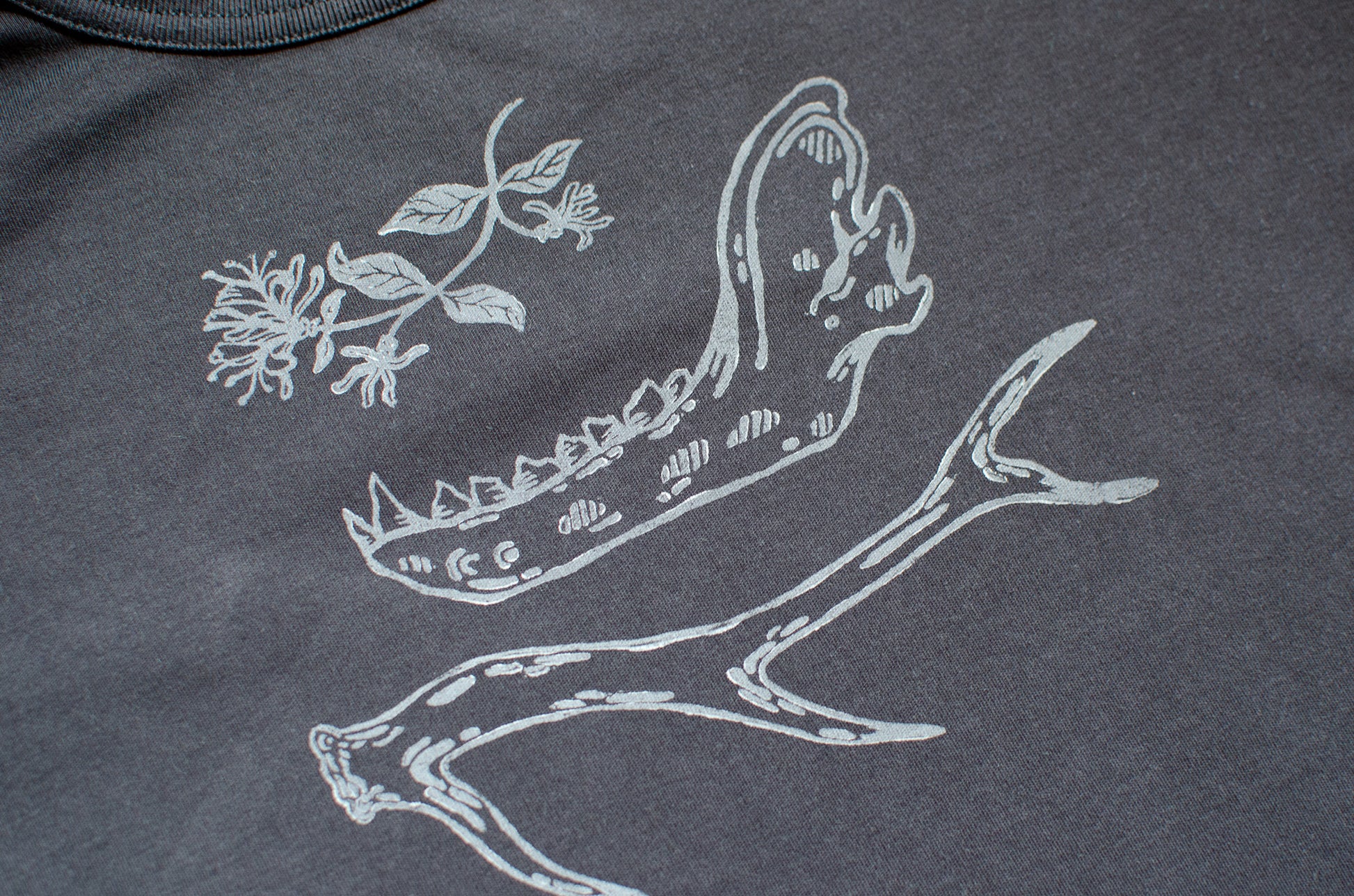 Black t-shirt with hand printed white honeysuckle, jawbone, and antler design.