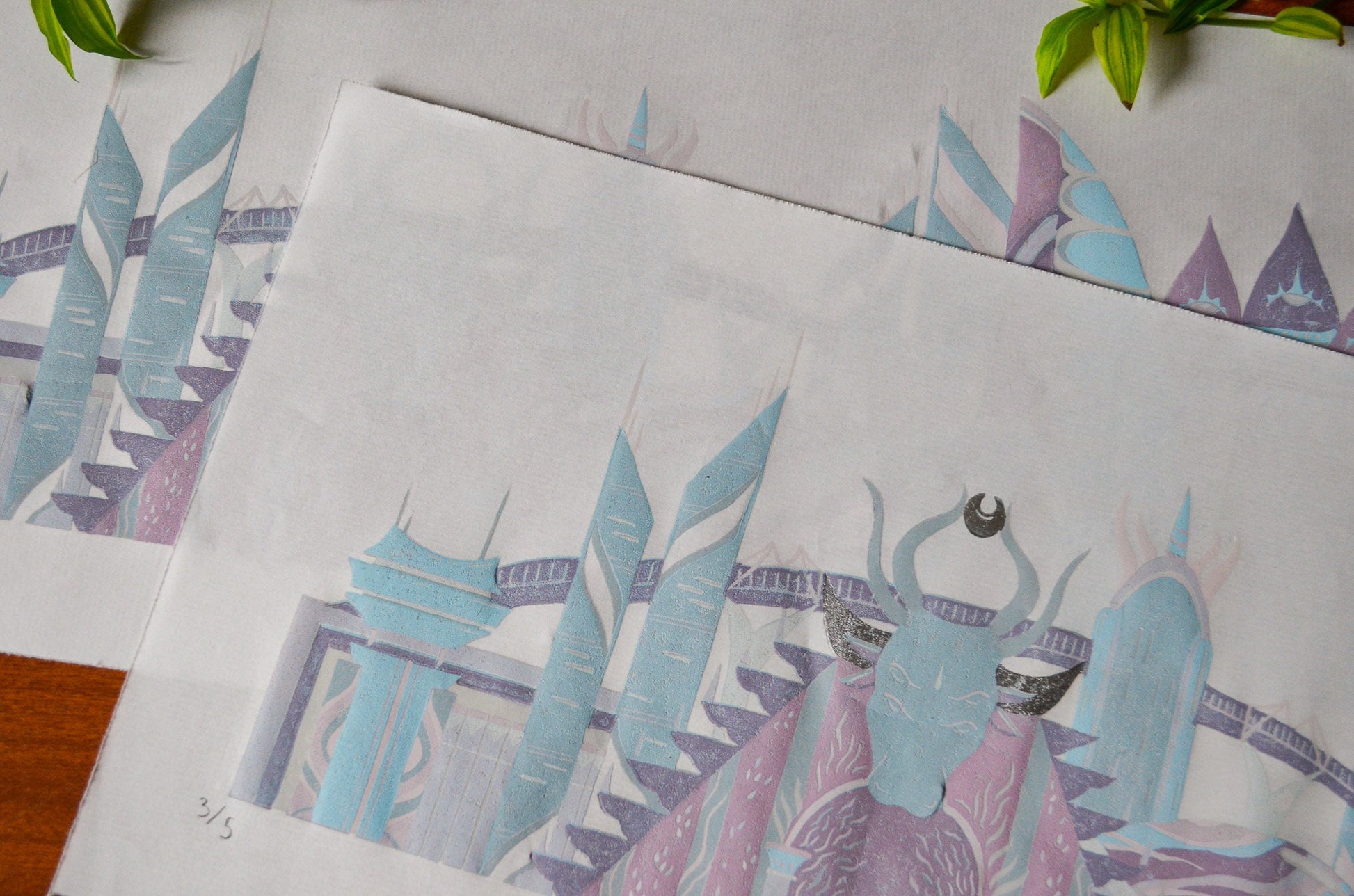 Close up of a pastel coloured linocut prints of futuristic sci-fi buildings