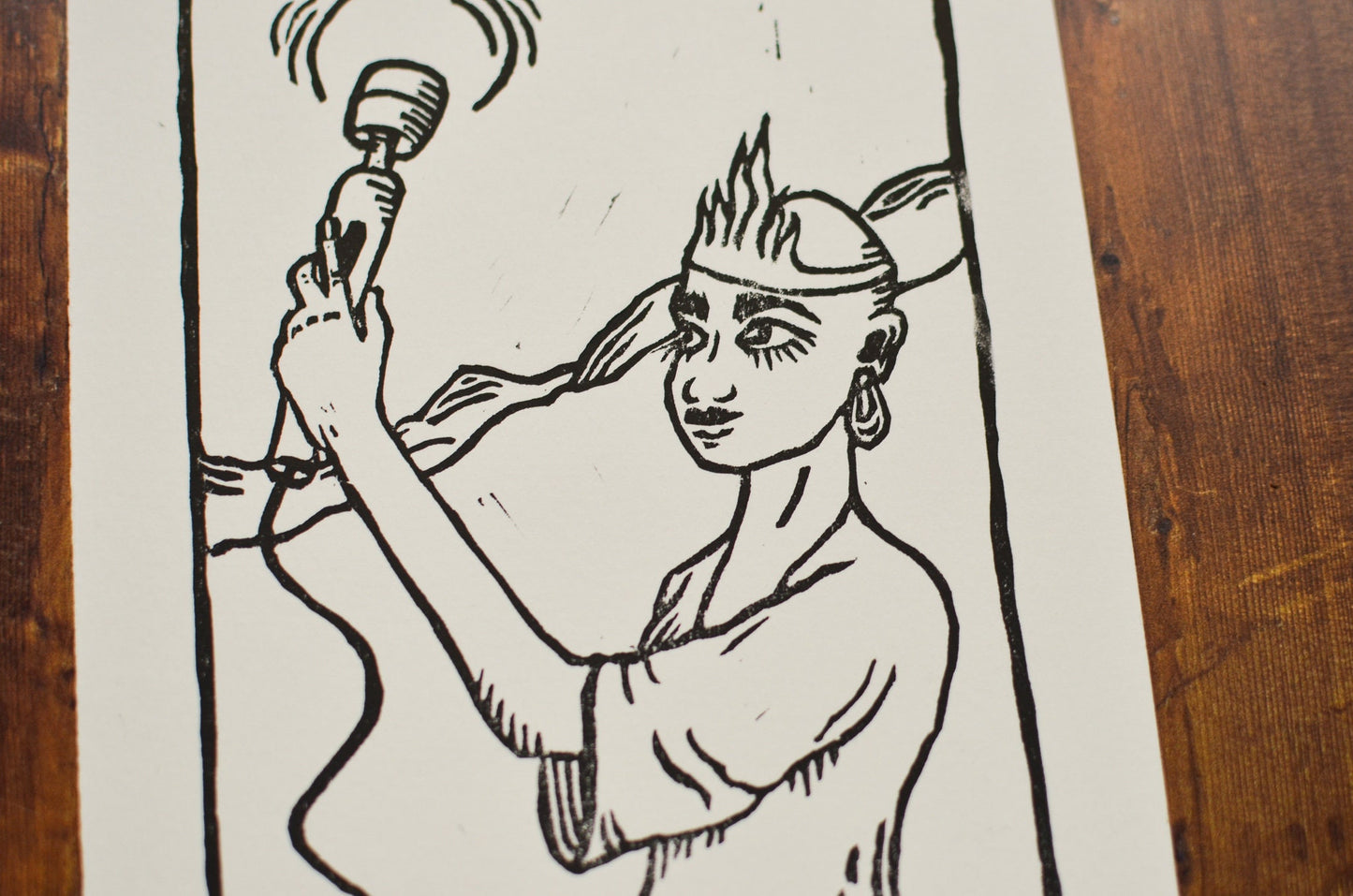 Black and white illustration of a person holding a hitachi wand on a wooden surface