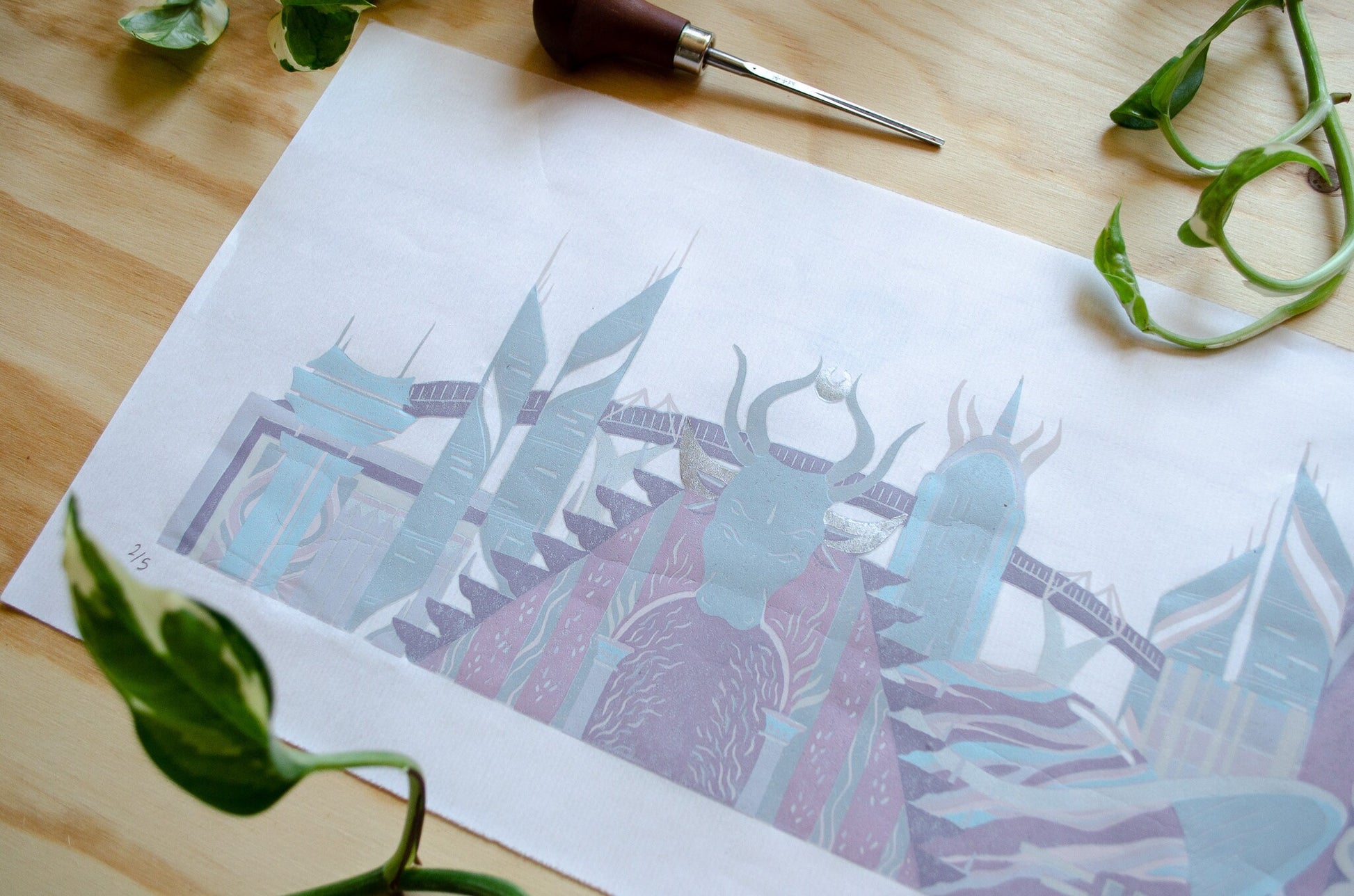 Artistic print of a stylized landscape with sci fi buildings on a wooden surface